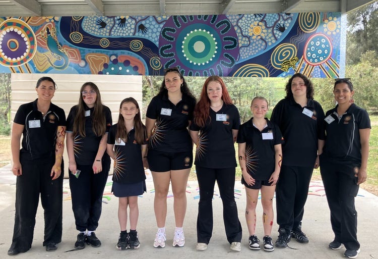Stars students lined up with Program mentors wearing black Stars polo shirts